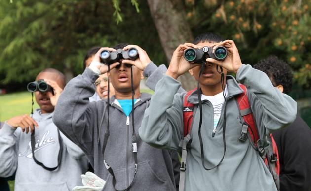 Young people looking through binoculars